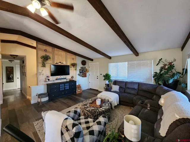 a living room with furniture fireplace and a view of kitchen