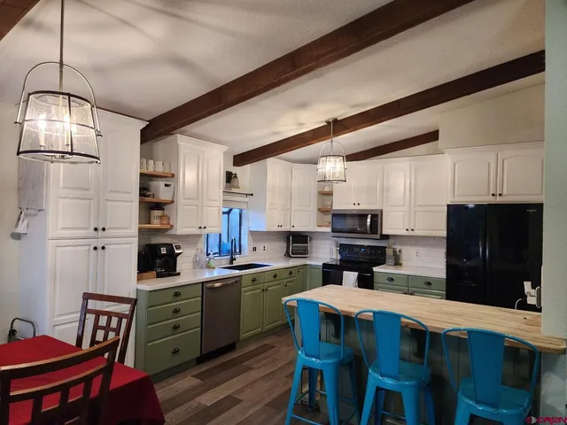 a kitchen with granite countertop a sink stainless steel appliances and cabinets