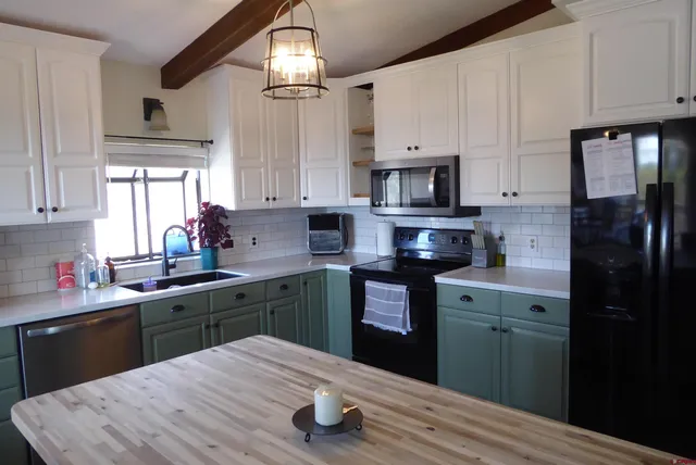 a kitchen with stainless steel appliances granite countertop a sink and cabinets
