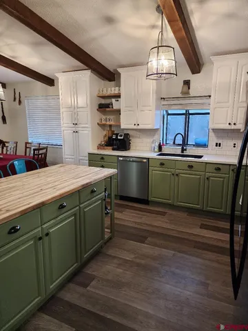 a room with sink and cabinets