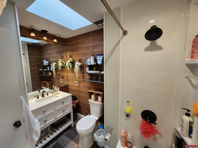 a bathroom with a toilet and a shower