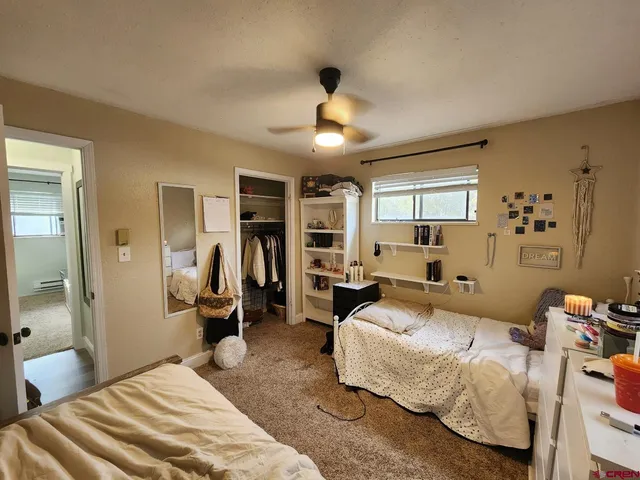 a spacious bedroom with a bed and a chandelier
