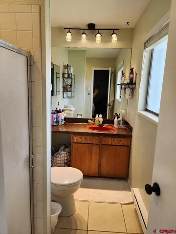 a bathroom with a toilet and a shower