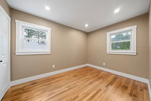 a view of room with window and wooden floor