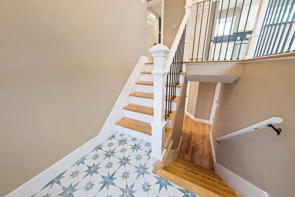 a view of staircase with white walls and a window