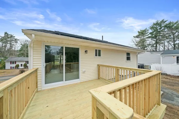 a view of balcony with furniture and wooden deck