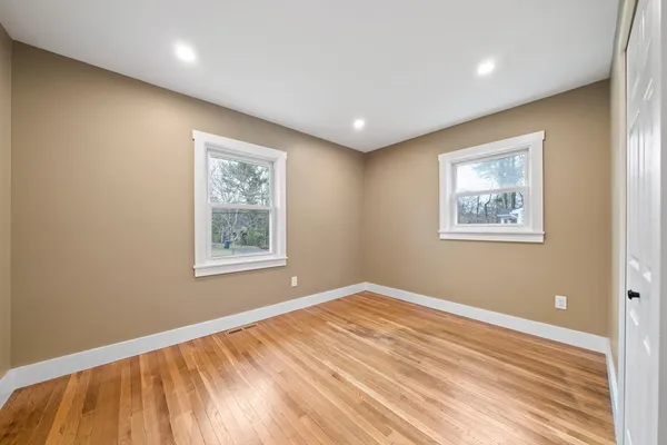 a view of a room with wooden floor and window