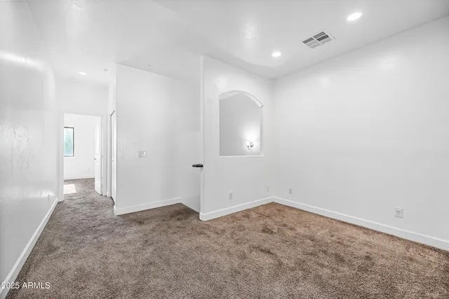 wooden floor in an empty room with a bathroom