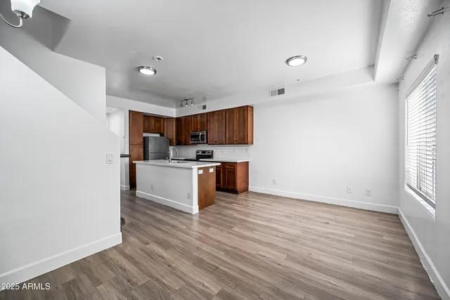 a view of kitchen with sink and wooden floor