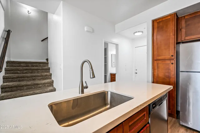 a kitchen with a refrigerator and a sink