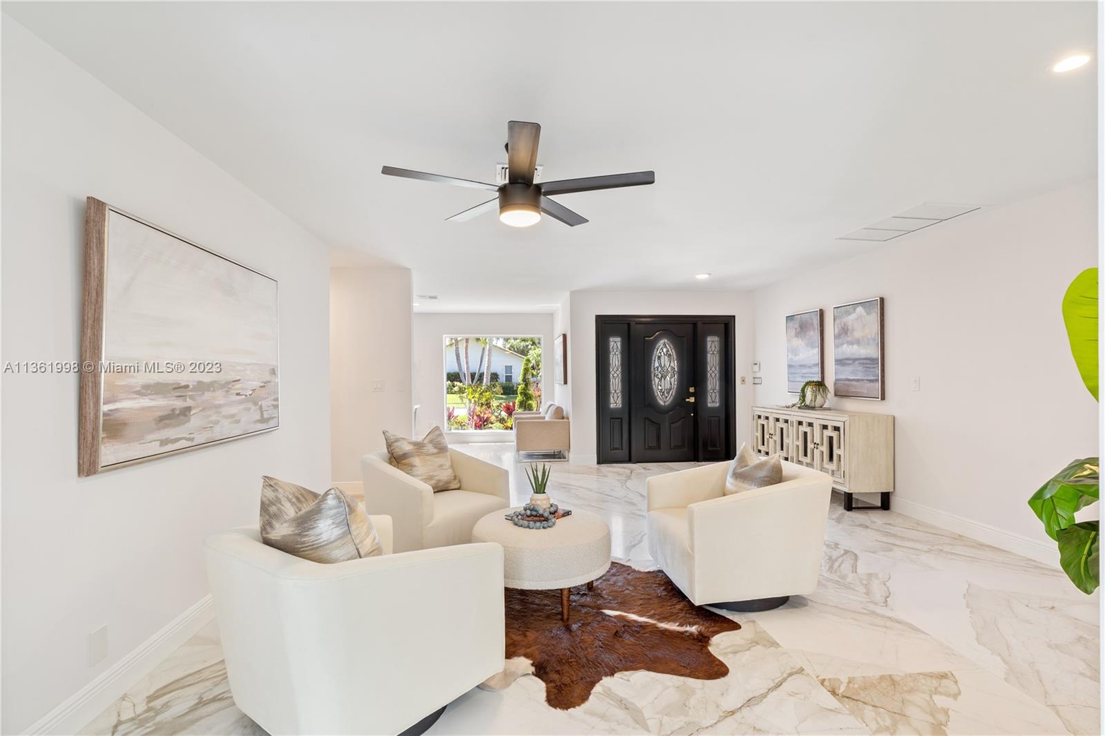 721 Southwest 15th Street Boca Raton, FL 33486 - Photo 16 of 46 a living room with furniture and a flat screen tv