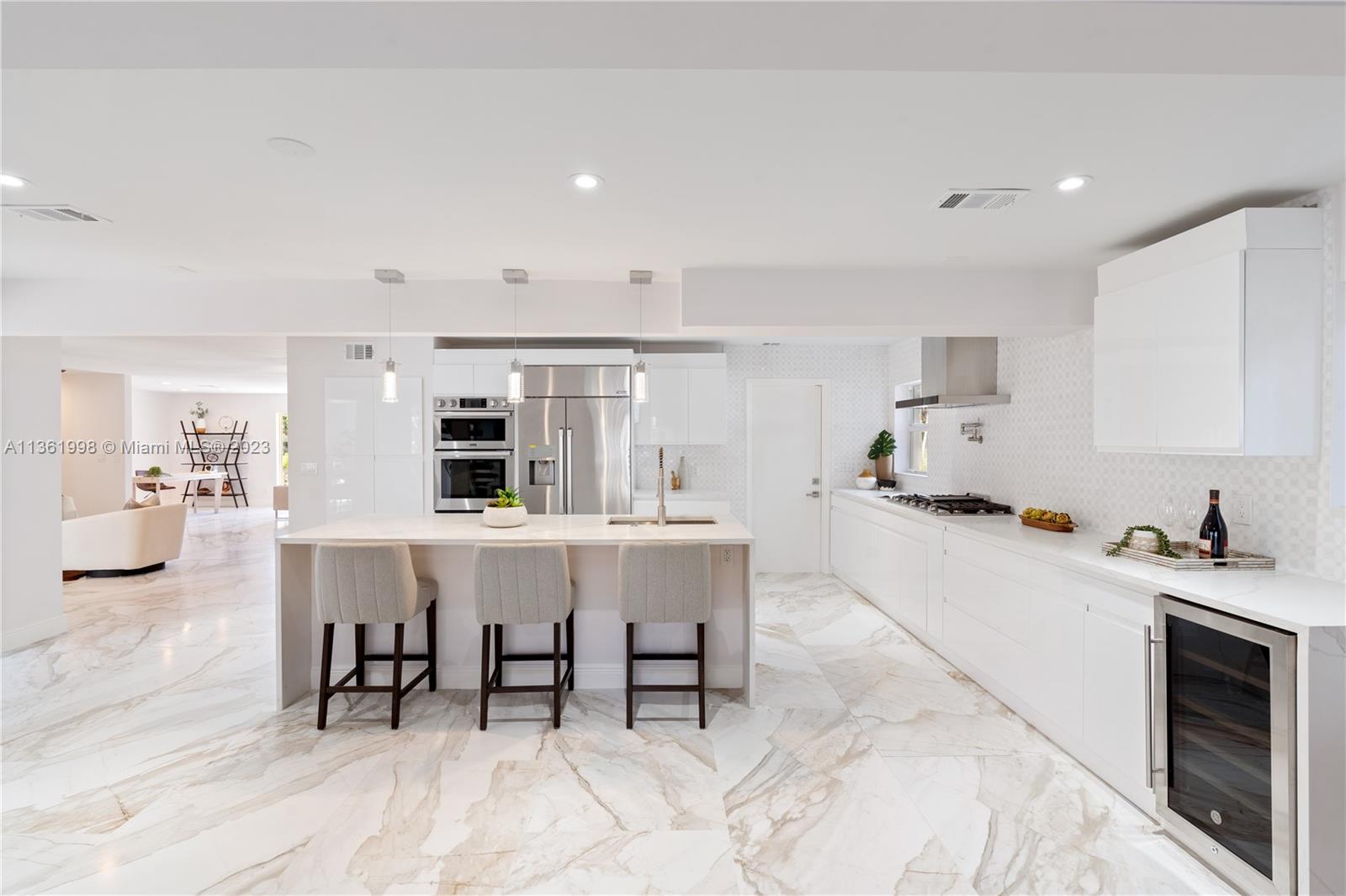 721 Southwest 15th Street Boca Raton, FL 33486 - Photo 18 of 46 a kitchen with a dining table chairs and wooden floor