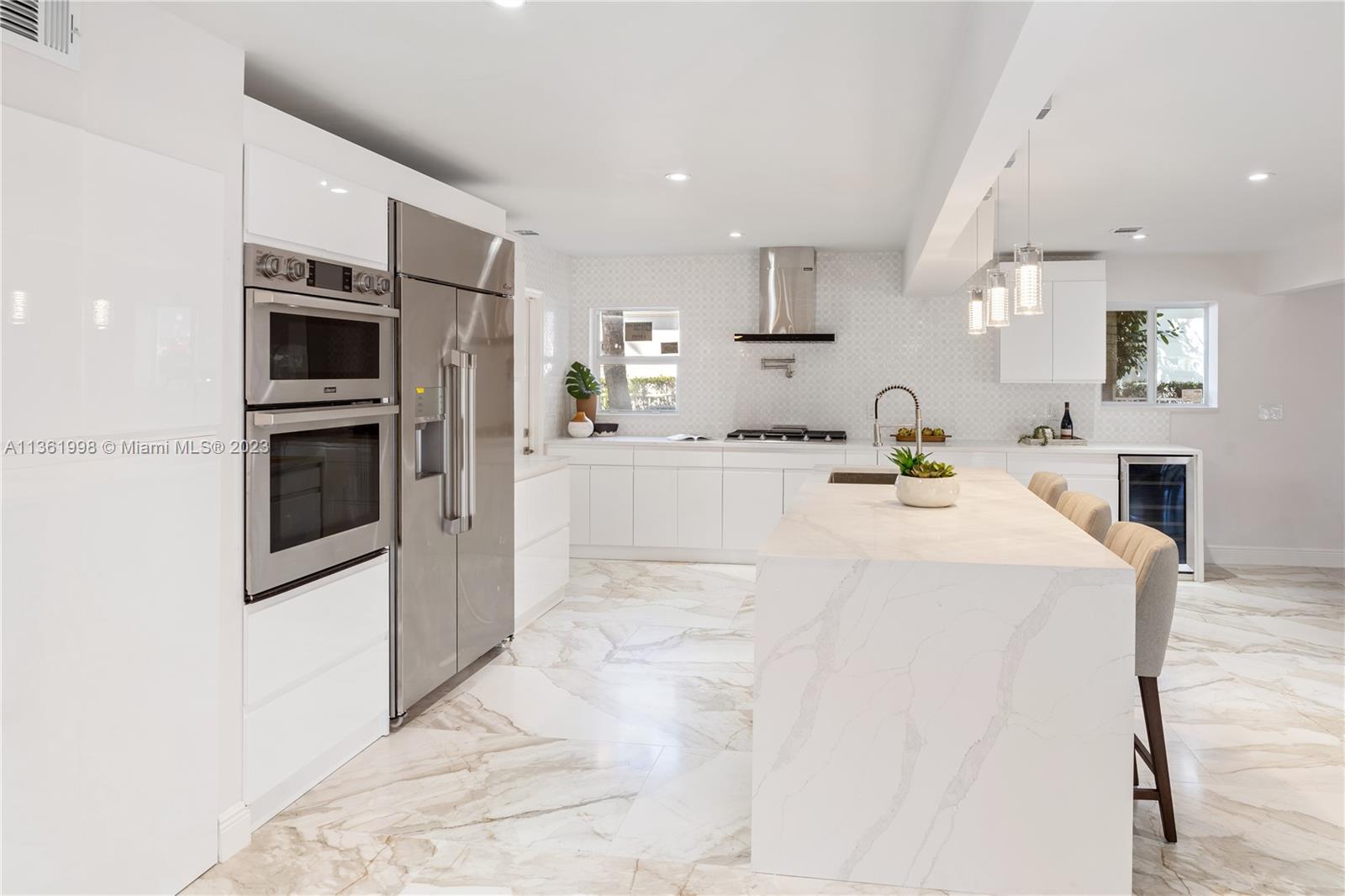 721 Southwest 15th Street Boca Raton, FL 33486 - Photo 20 of 46 a kitchen with stainless steel appliances kitchen island granite countertop a sink and cabinets