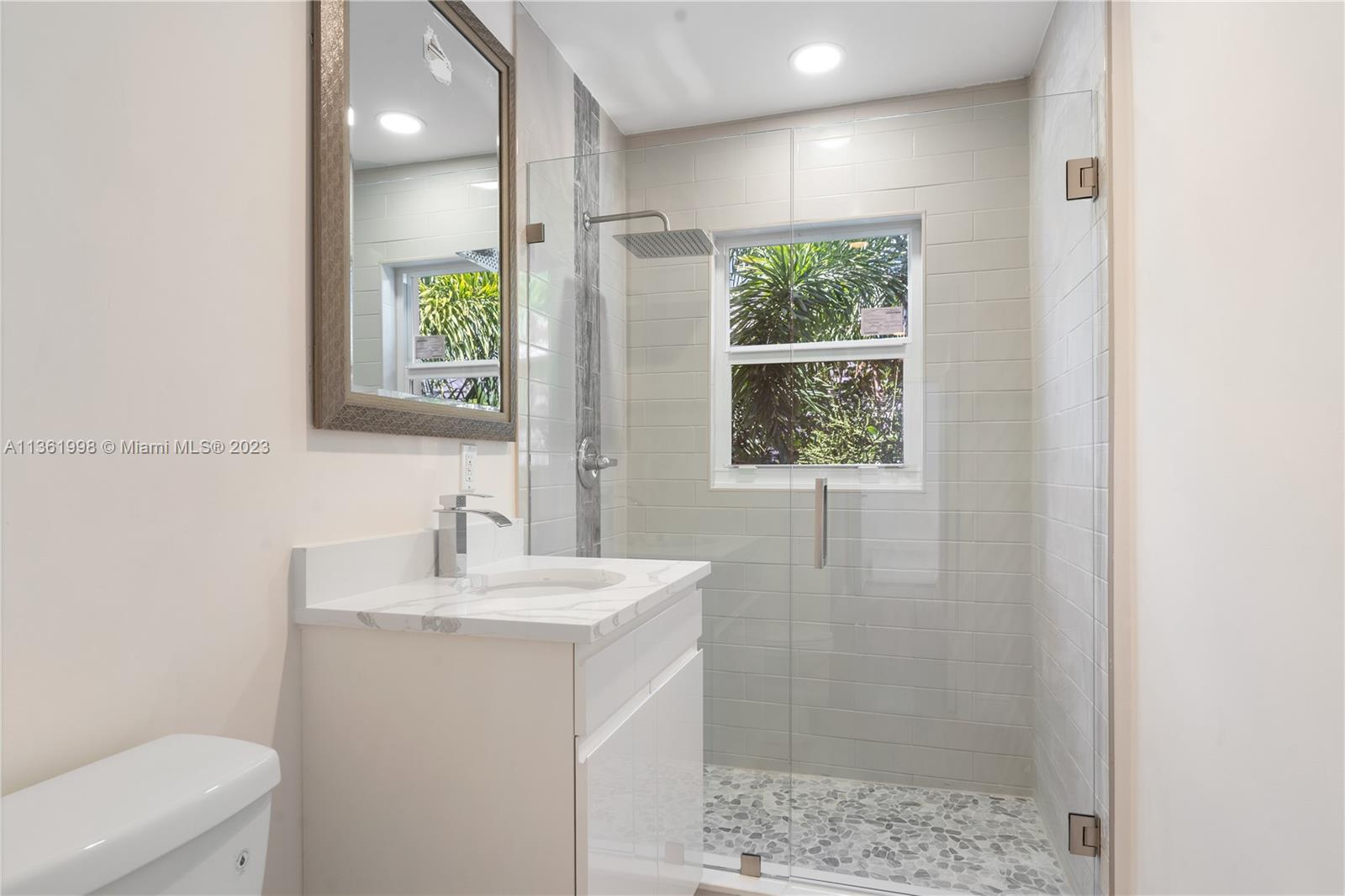 721 Southwest 15th Street Boca Raton, FL 33486 - Photo 29 of 46 a bathroom with a sink a toilet and shower