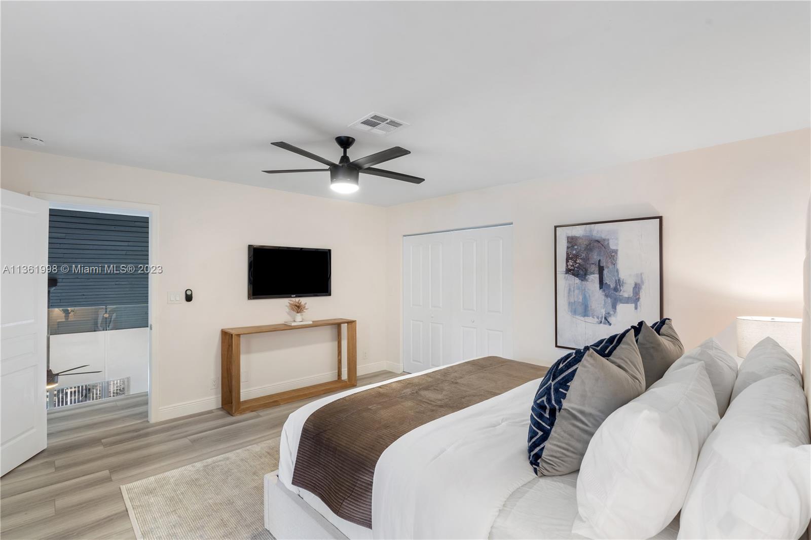 721 Southwest 15th Street Boca Raton, FL 33486 - Photo 30 of 46 a bedroom with a bed and a flat screen tv