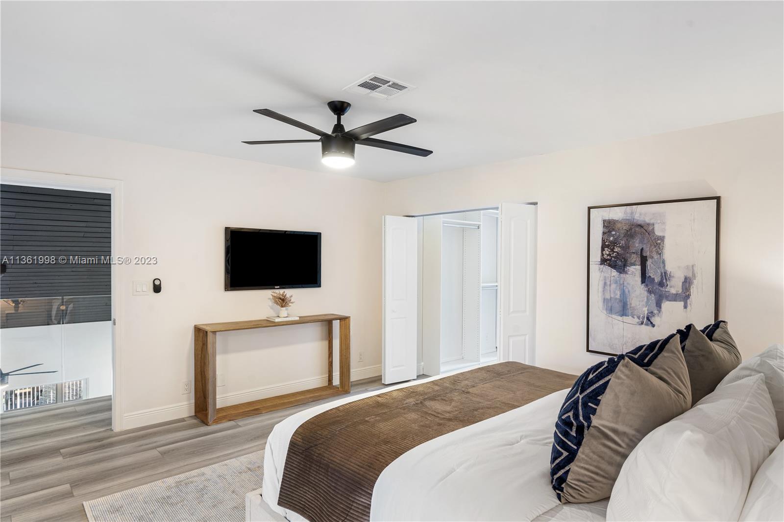 721 Southwest 15th Street Boca Raton, FL 33486 - Photo 31 of 46 a bedroom with a bed and a flat screen tv