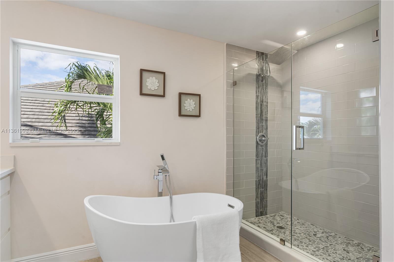 721 Southwest 15th Street Boca Raton, FL 33486 - Photo 34 of 46 a white bath tub sitting next to a shower