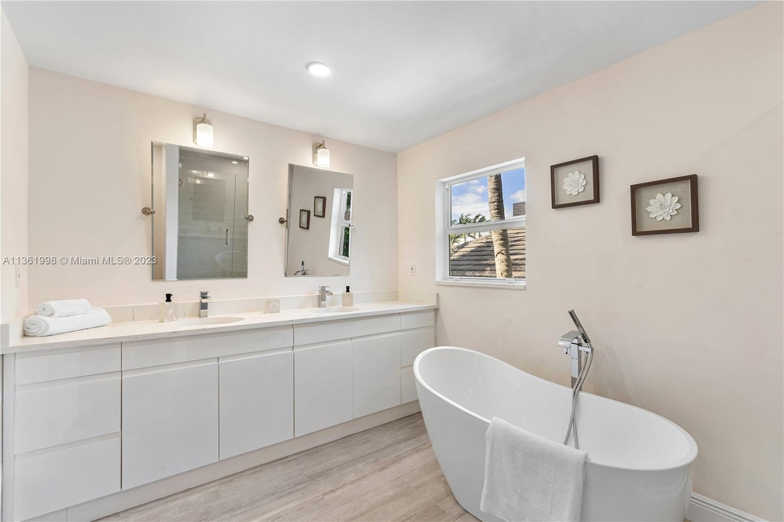 721 Southwest 15th Street Boca Raton, FL 33486 - Photo 35 of 46 a bathroom with a double vanity sink a mirror and a