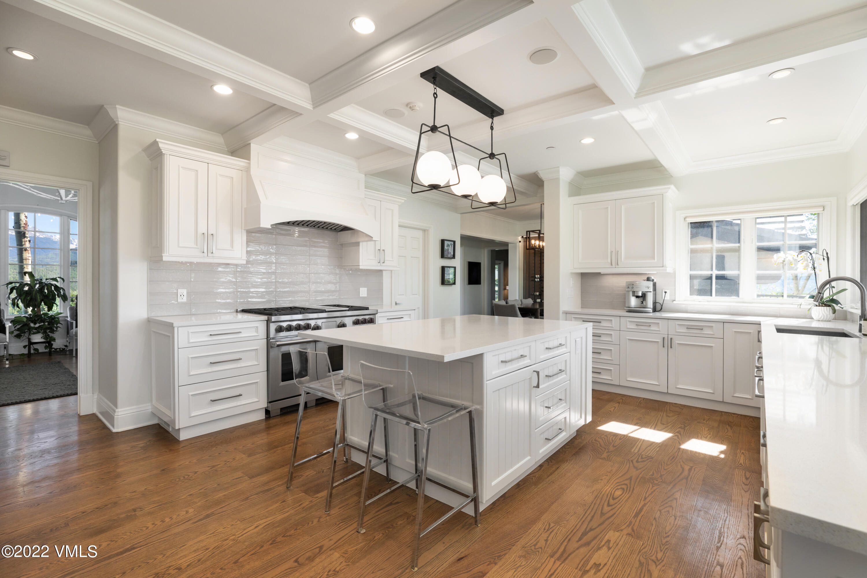 100 Casteel Ridge Edwards, CO 81632 - Photo 4 of 36 a large white kitchen with cabinets and wooden floor