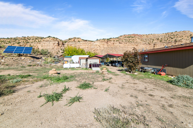 3135 North Thompson Cyn Road Green River, UT 84525 - Photo 35 of 41 View of yard with an outdoor structure and a mountain view