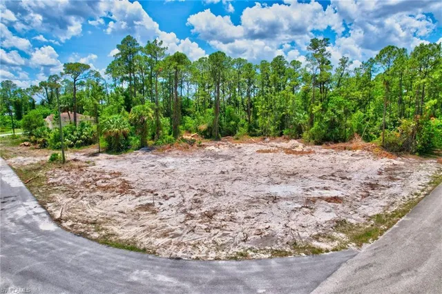 a view of a yard with a wooden fence
