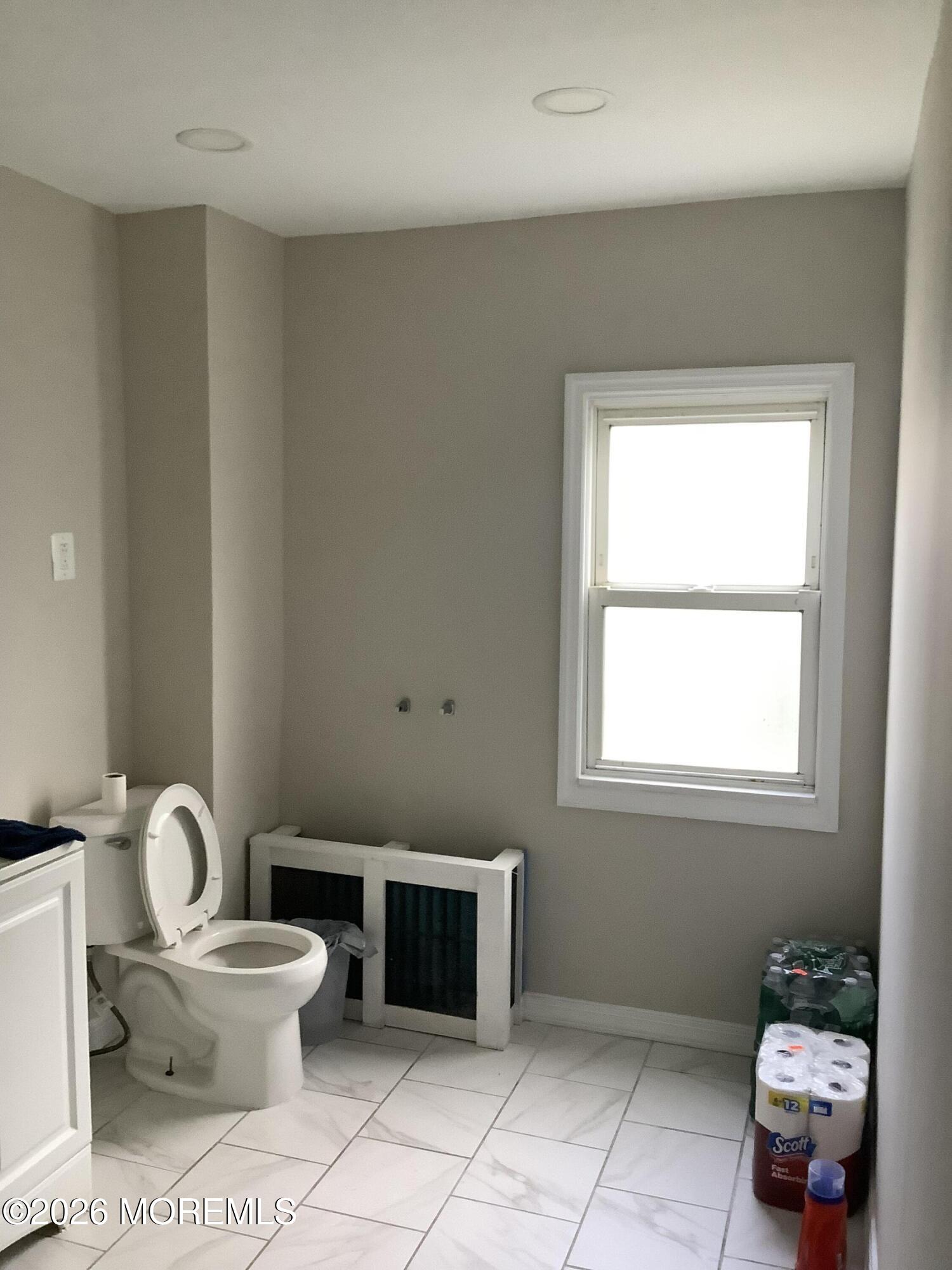 242 1st Street Keyport, NJ 07735 - Photo 12 of 23 a bathroom with a toilet sink and a mirror