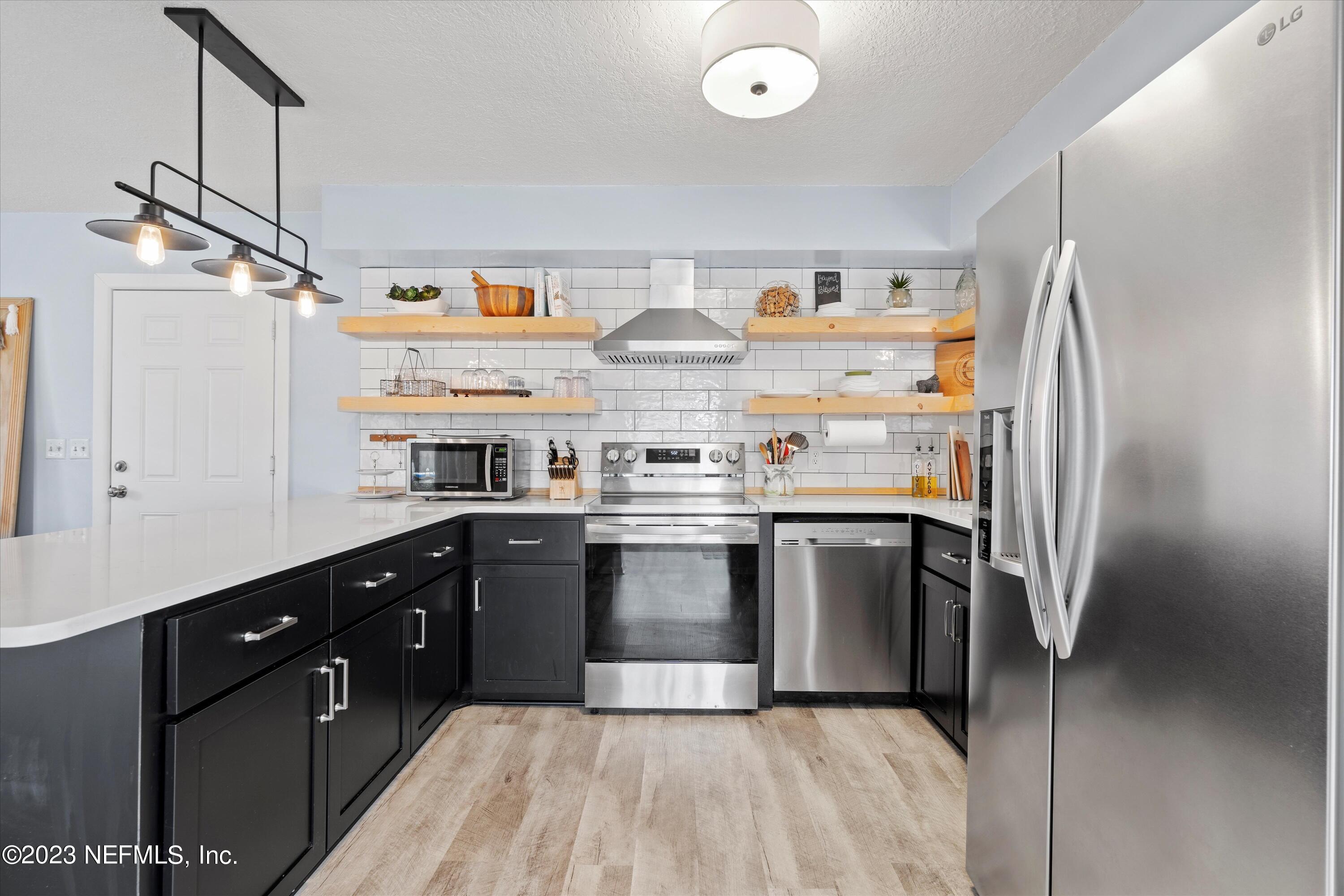 3972 Eunice Road Jacksonville, FL 32250 - Photo 3 of 38 a kitchen with stainless steel appliances granite countertop a refrigerator and a sink