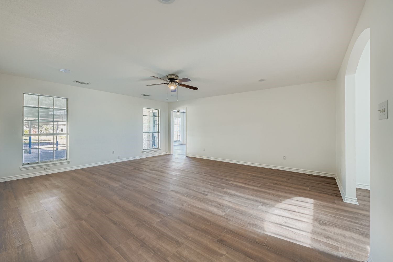 34411 Fulshear Farms Road Fulshear, TX 77441 - Photo 14 of 29 a view of an empty room with wooden floor and a window