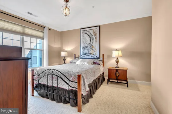 a bedroom with bed and a window