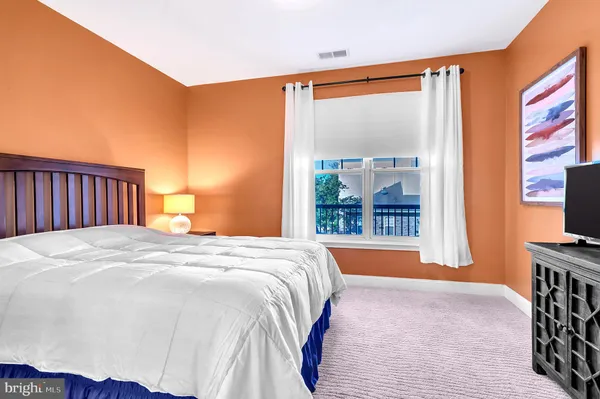 a bedroom with a bed table and chair