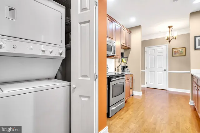 a view of washer and dryer with kitchen in the background