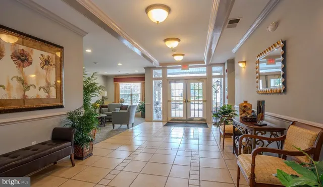a lobby with furniture and wooden floor