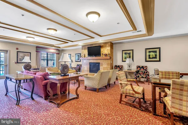 a living room with fireplace furniture and a flat screen tv