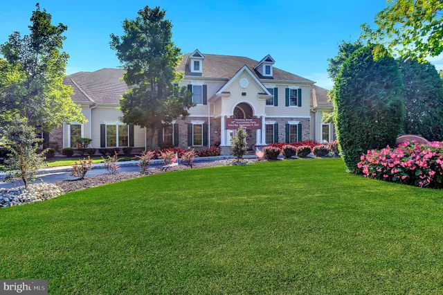 a front view of building with yard and green space