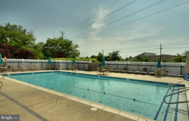 a view of a swimming pool with a lawn chairs