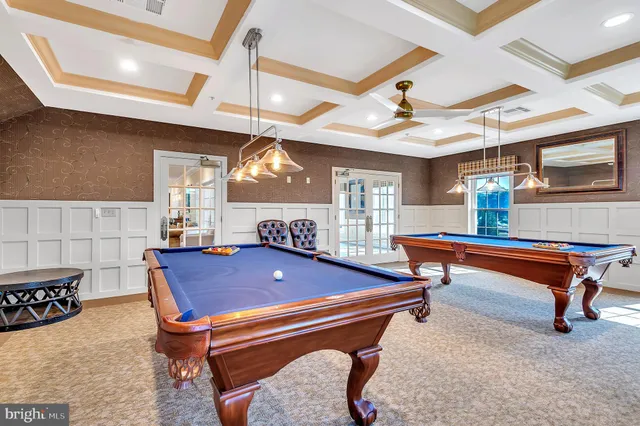 a room with furniture pool table and windows