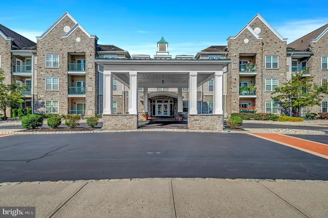 front view of a brick house with a small yard