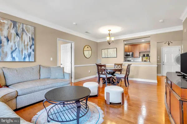 a living room with furniture and kitchen view