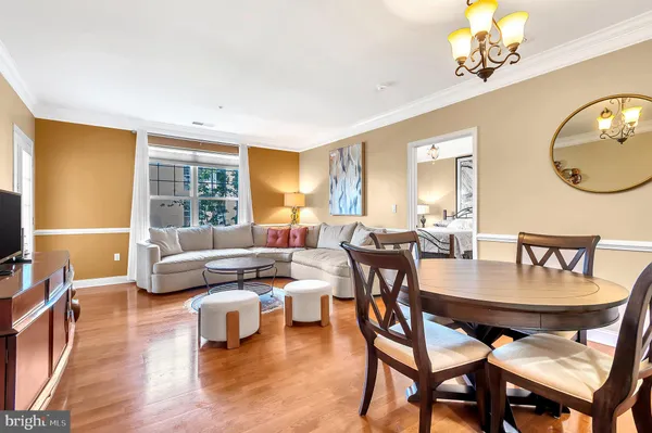 a living room with furniture a fireplace and a chandelier