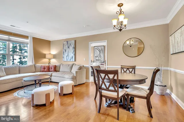 a view of a dining room with furniture a chandelier and wooden floor