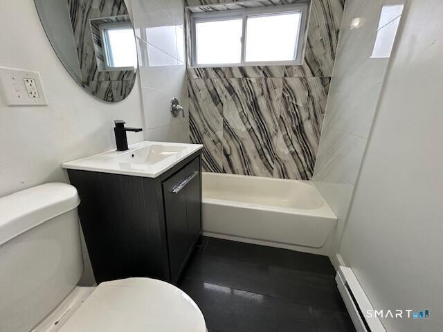 114 Grove Street, Unit 12 Stamford, CT 06901 - Photo 11 of 13 a bathroom with a sink a toilet a mirror and bathtub