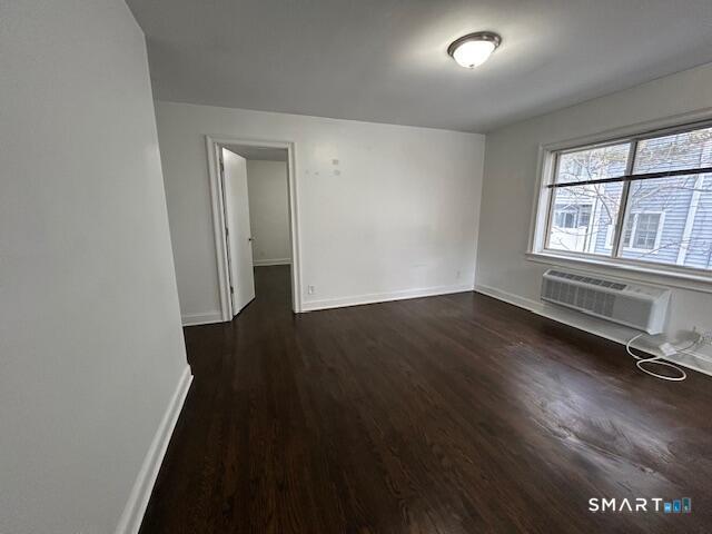 114 Grove Street, Unit 12 Stamford, CT 06901 - Photo 12 of 13 an empty room with wooden floor and windows