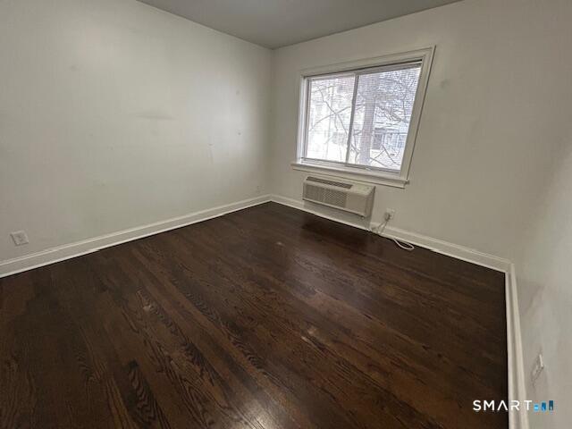 114 Grove Street, Unit 12 Stamford, CT 06901 - Photo 7 of 13 an empty room with wooden floor and windows