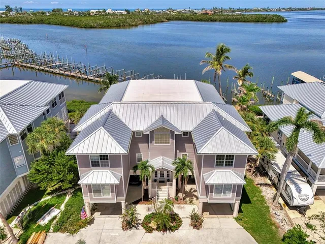 an aerial view of a house with garden space and lake view