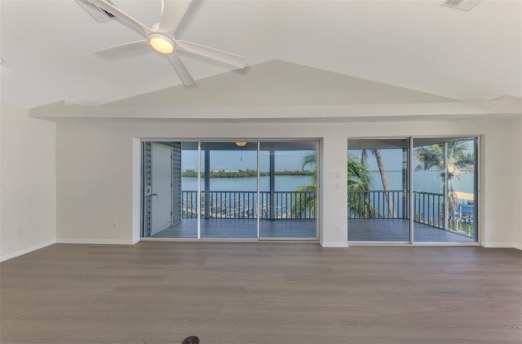 1380 Beach Road, Unit 4 Englewood, FL 34223 - Photo 13 of 47 a view of an empty room with wooden floor and a window
