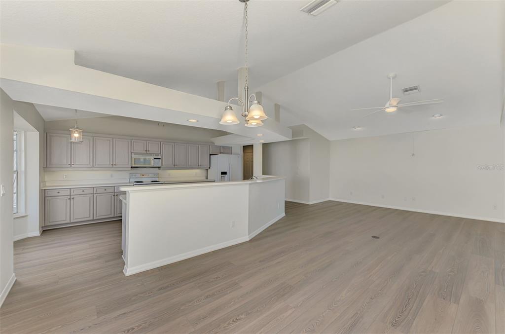 1380 Beach Road, Unit 4 Englewood, FL 34223 - Photo 17 of 47 a view of a kitchen with kitchen island a sink stainless steel appliances and cabinets