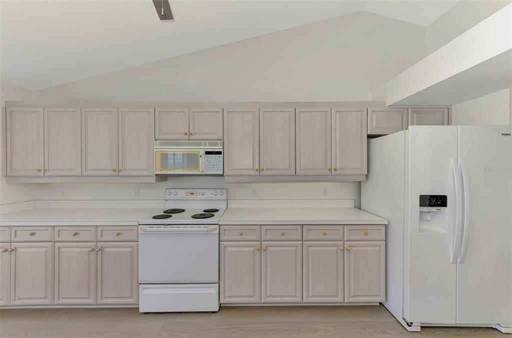 1380 Beach Road, Unit 4 Englewood, FL 34223 - Photo 21 of 47 a white refrigerator freezer sitting inside of a kitchen