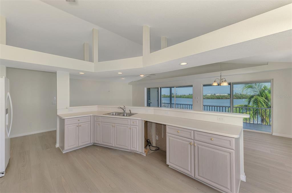 1380 Beach Road, Unit 4 Englewood, FL 34223 - Photo 22 of 47 a large white kitchen with a sink and dish washer
