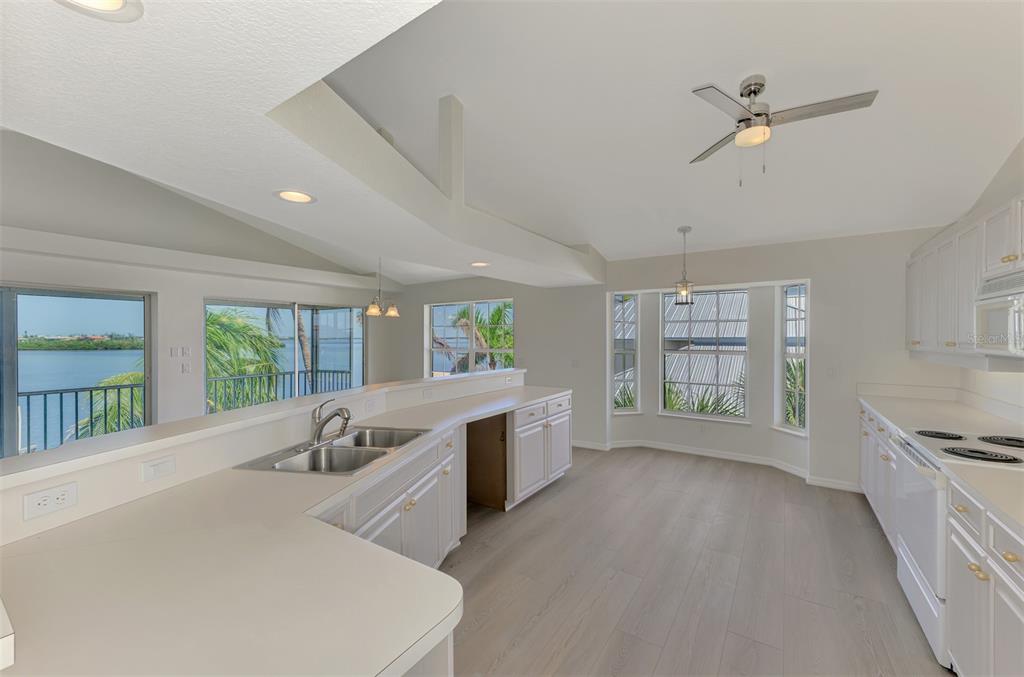 1380 Beach Road, Unit 4 Englewood, FL 34223 - Photo 23 of 47 a large white kitchen with a large window