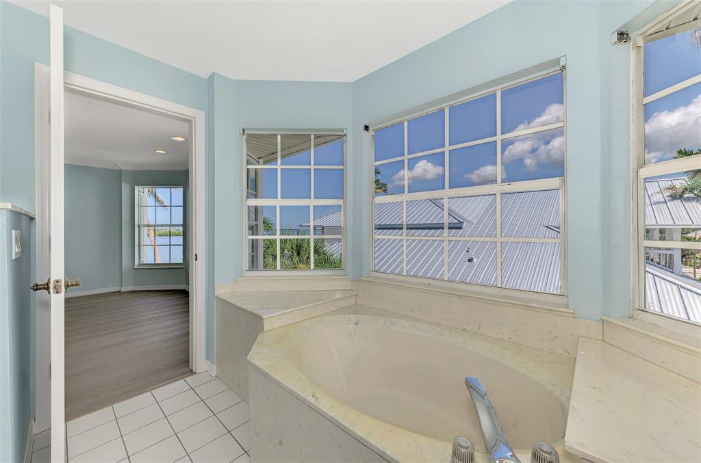 1380 Beach Road, Unit 4 Englewood, FL 34223 - Photo 31 of 47 wooden floor with window in an empty room